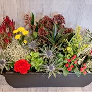 Planted container with flowers